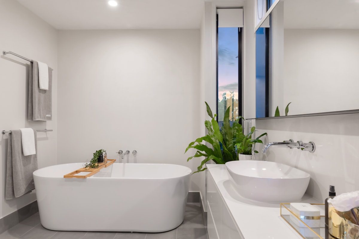 Contemporary bathroom with a vanity and bright finishes